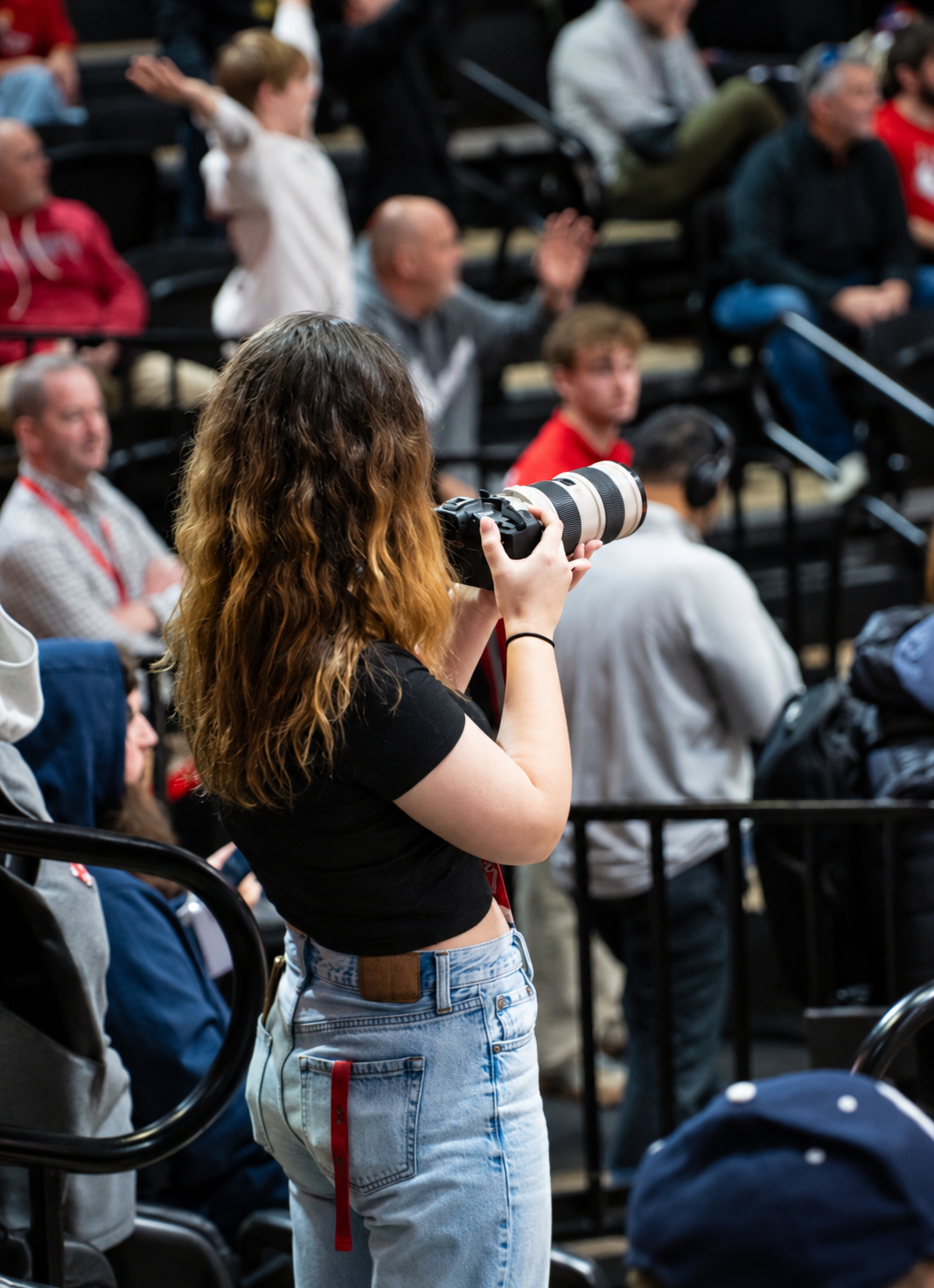 Emily photographing a basketball game