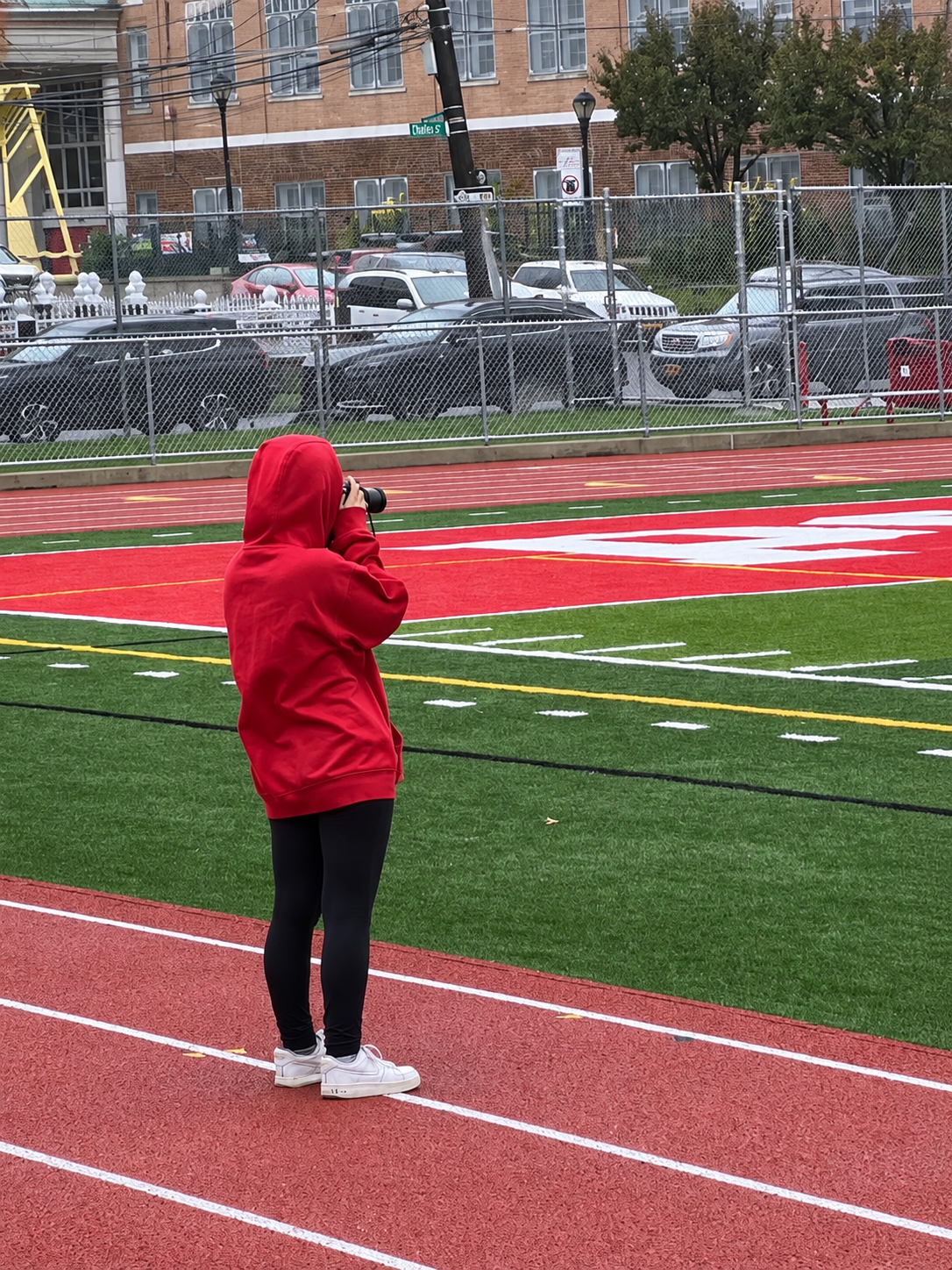 Emily taking photographs from the sidelines